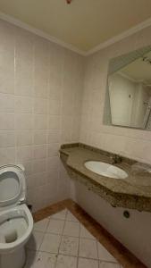 a bathroom with a toilet and a sink and a mirror at Luxury Sea View Apartment in Four Seasons Alexandria in Alexandria +14 photos