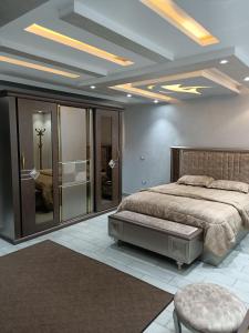 a bedroom with a large bed and a room with at اكتوبر الحصري 6 October in 6th Of October