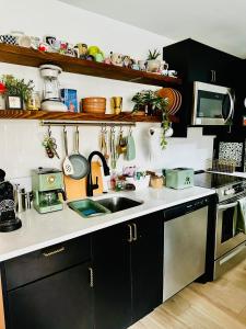 a kitchen with a sink and a stove at Heart of Fishtown with parking! in Philadelphia +21 photos