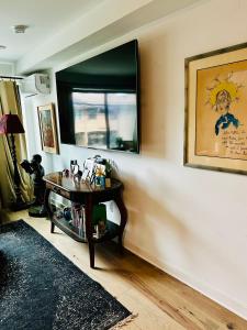 a living room with a table and a window at Heart of Fishtown with parking! in Philadelphia