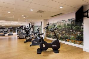 a gym with several exercise bikes in a room at NH Amsterdam Noord in Amsterdam +32 photos