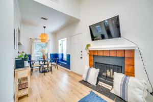 a living room with a fireplace and a tv on the wall at 3 Mi to Downtown Dallas Sleek Condo with Patio in Highland Park