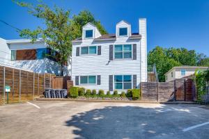 a white house with a fence in front of it at 3 Mi to Downtown Dallas Sleek Condo with Patio in Highland Park