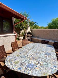 una mesa con un mosaico de mantel en un patio en Villa Damare, en Taranto 24 fotos más