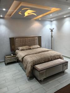 a bedroom with a bed with a cross on the wall at اكتوبر الحصري 6 October in 6th Of October