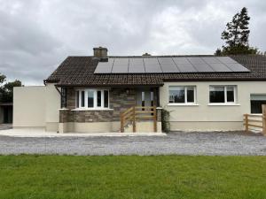 a house with solar panels on the roof at Country Escape in Cloneen