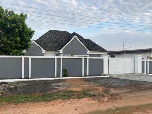 a house with a white fence and a garage at 2BR House in Gbawe in Gbawe