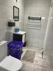 a white bathroom with a toilet and a sink at 2BR House in Gbawe in Gbawe +10 photos