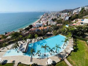 an overhead view of a swimming pool next to the ocean at 3-Bedroom Condo in the romantic zone in Puerto Vallarta