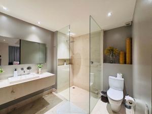 a bathroom with a shower and a toilet and a sink at 3-Bedroom Condo in the romantic zone in Puerto Vallarta +13 photos