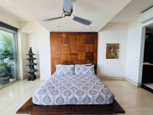 a bedroom with a bed with a ceiling fan at 3-Bedroom Condo in the romantic zone in Puerto Vallarta