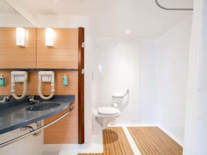 a bathroom with a toilet and a sink at Novotel Suites Cannes Centre in Cannes +36 photos