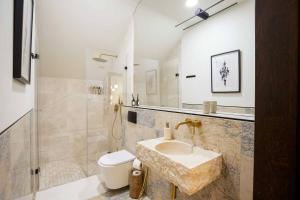 a bathroom with a sink and a toilet at Villa Aleksandrow SPA in Aleksandrów +93 photos