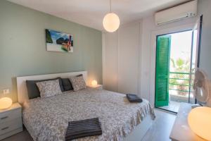 a bedroom with a bed and a large window at Duplex in Playa De Las Américas-center in Playa de las Americas +31 photos