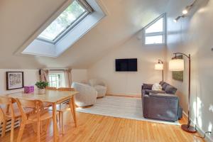 a living room with a dining table and a skylight at Hike and Leaf Peep Couples Retreat in Waterbury! in Waterbury