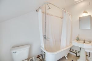 a bathroom with a tub and a toilet and a sink at Hike and Leaf Peep Couples Retreat in Waterbury! in Waterbury +17 photos