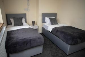 Giường trong phòng chung tại Restful 3-Bed Retreat Tilbury