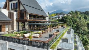 an image of a building with a balcony with a restaurant at Plataran Puncak Suites in Puncak