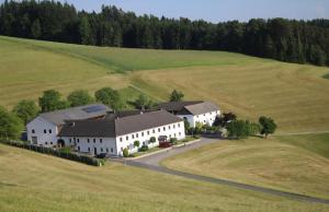 an aerial view of a large white house in a field at Wohnung im ländlichen Flair in Bad Zell