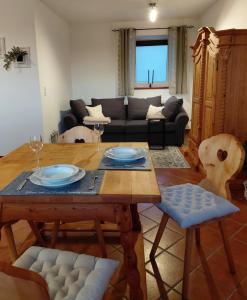 a living room with a table and a couch at Wohnung im ländlichen Flair in Bad Zell