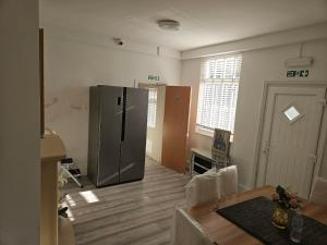 a kitchen with a stainless steel refrigerator in a room at New Horizon Lodge in Leigh