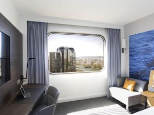 a hotel room with a window with a view of the city at Novotel Paris Centre Tour Eiffel in Paris +202 photos
