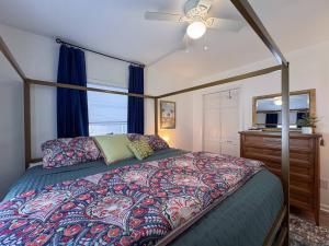 a bedroom with a canopy bed and a dresser at HOT TUB + private backyard + riverwalk! in Wilmington +67 photos