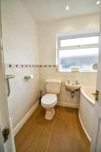 a bathroom with a toilet and a sink and a tub at Buckingham Terrace - 4 Bedrooms - Sleeps 7 in Redcar