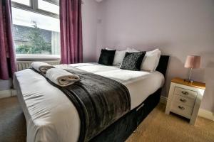 a bedroom with a bed with blankets and a window at Buckingham Terrace - 4 Bedrooms - Sleeps 7 in Redcar