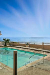 a swimming pool with the ocean in the background at Solana Oceanfront with Pool, Spa, Ocean Views in Solana Beach