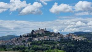 a town on top of a hill with houses at Le Contrade in Amelia
