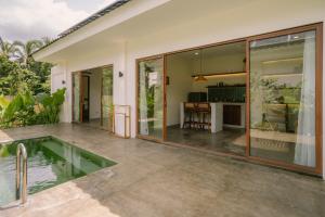 an external view of a house with a swimming pool at Ananda House in El Nido