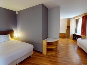 a hotel room with a bed and a table and a chair at Ibis Bratislava Centrum in Bratislava +61 photos