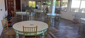 a room with tables and chairs in a restaurant at hotel Mountain Dream Resort El Cocuy in El Cocuy