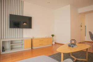 a living room with a tv on a wall at Sleek 2BR in Miraflores in Lima