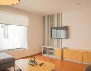 a living room with a tv on the wall at Sleek 2BR in Miraflores in Lima