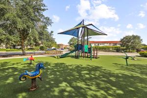 a park with a playground with a play equipment at Family 4BR Private Pool BBQ Resort Stay in Kissimmee