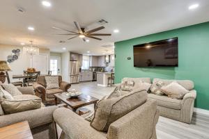 a living room with furniture and a green wall at 3 Mi to Desert Diamond Arena Peoria Home with Yard! in Shamrock Mobile Home Park