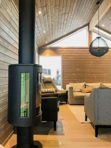a living room with a fireplace in the middle of the room at Modern Cabin With Breathtaking View At Norefjell in Eggedal