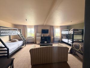 a room with two bunk beds and a couch at Super 8 by Wyndham Macon in Macon