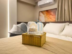 a basket of towels and towels on a bed at Áurea Bauten Cabo Branco Genius Flats in João Pessoa