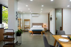 a bedroom with a bed and a table and chairs at Norte cali -Bosque Living -204 in Cali +28 photos