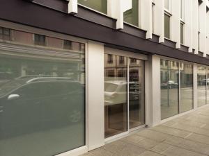 a store front with glass windows on a street at Résidence Studio Genève Centre in Geneva