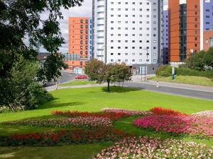 a park with flowers in the middle of a city at ibis Leeds Centre Marlborough Street in Leeds