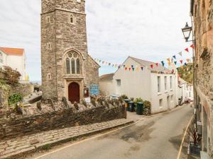 a street in front of a church with flags at Owls Roost in Saint Goran