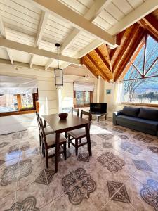 a living room with a table and a couch at La Casita de Arriba in San Martín de los Andes