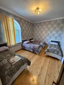 a bedroom with two beds and a window at Mountain Villa with Scenic views in Quba