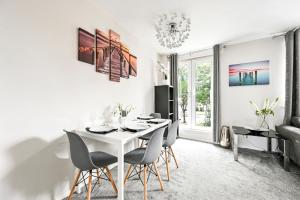 a white dining room with a white table and chairs at Modern 3-Bed Maisonette - Epping High Street - Parking - LMV Property in Epping