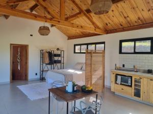 a bedroom with a bed and a wooden ceiling at Chalé Alto padrão in Brazópolis +16 photos
