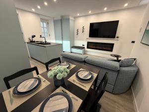 a living room with a table and a couch at La Casita del Mar in Combarro